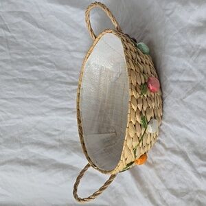 Vintage woven grass basket with rafia embellishments